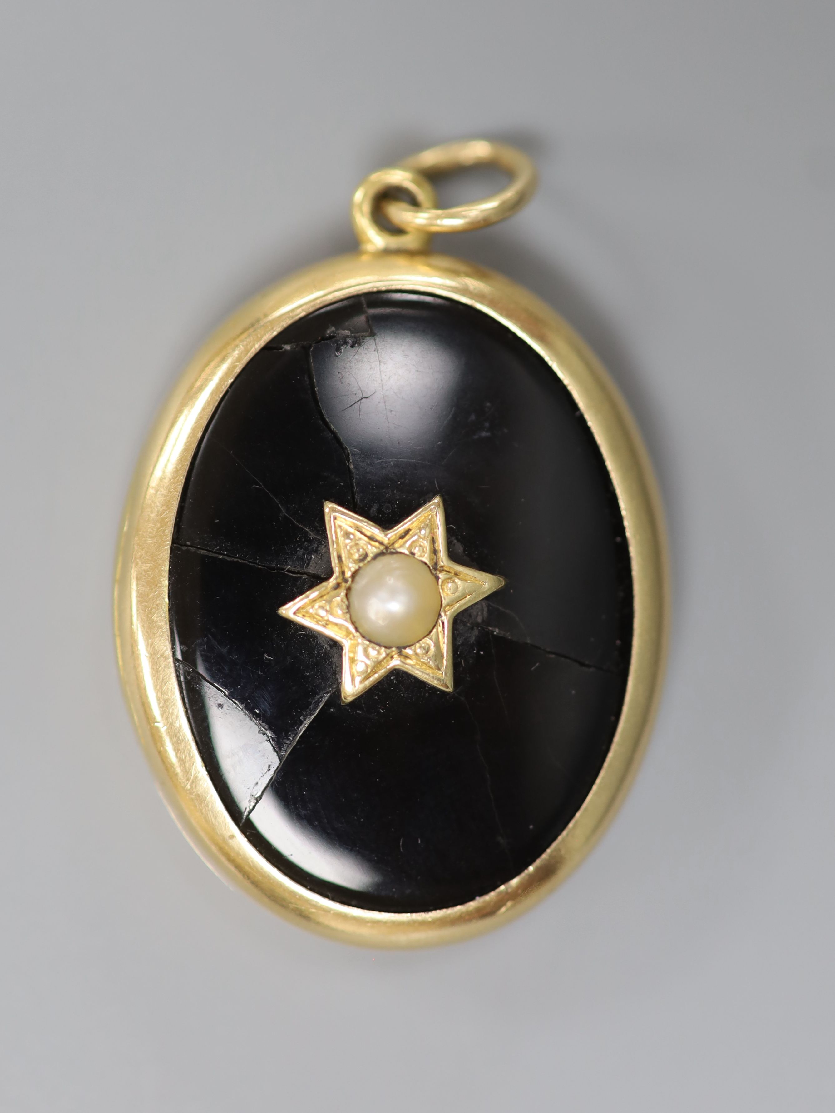 A Victorian Dublin oval yellow metal black enamel and split pearl set locket (Irish by family repute) (a.f.), 33mm, gross 17 grams.